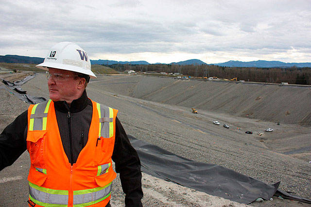 Scott Barden stands next to the pit that will house the newest, and possibly final, section of the Cedar Hills Regional Landfill near Maple Valley. The pit is 120 feet deep, and around another 180 feet will be built on top of it over the next decade (Aaron Kunkler Photo).