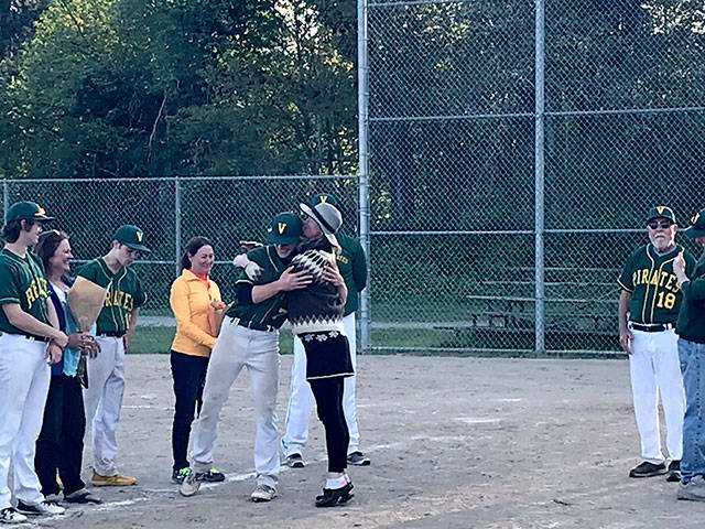 VHS senior and Pirates baseball player Ary Dulfer hugs his mother on Senior Night, while (from left) teammates Tyler Lowell and his mother, and Mitchell Boles and his mother, and coach Greg McElroy (far right) look on (Courtesy Photo).