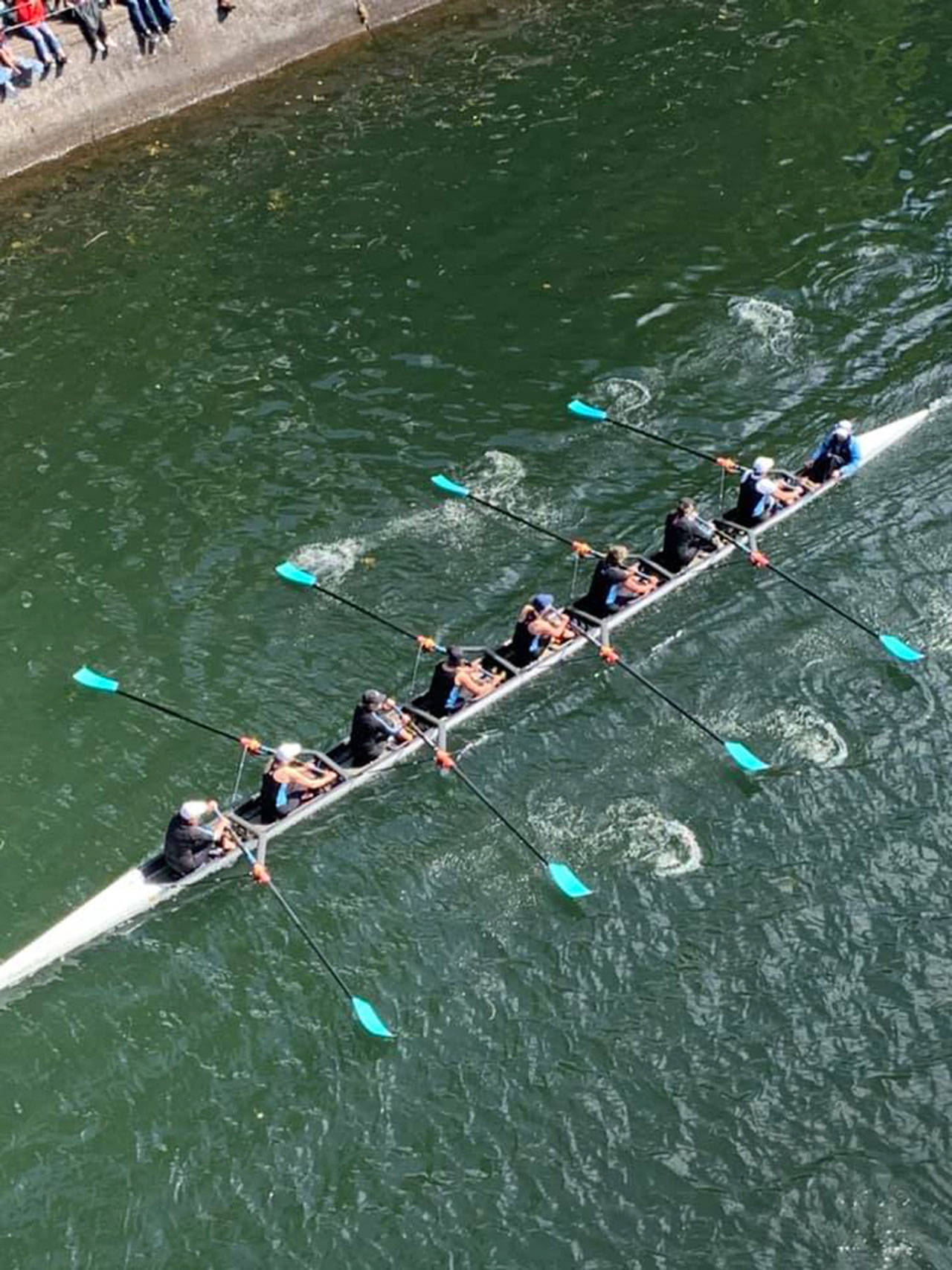 The Vashon Island Rowing Club’s masters women’s eight rows out from under the Montlake Bridge on their way to a third-place finish at last Saturday’s Opening Day regatta in Seattle. (Courtesy Photo)