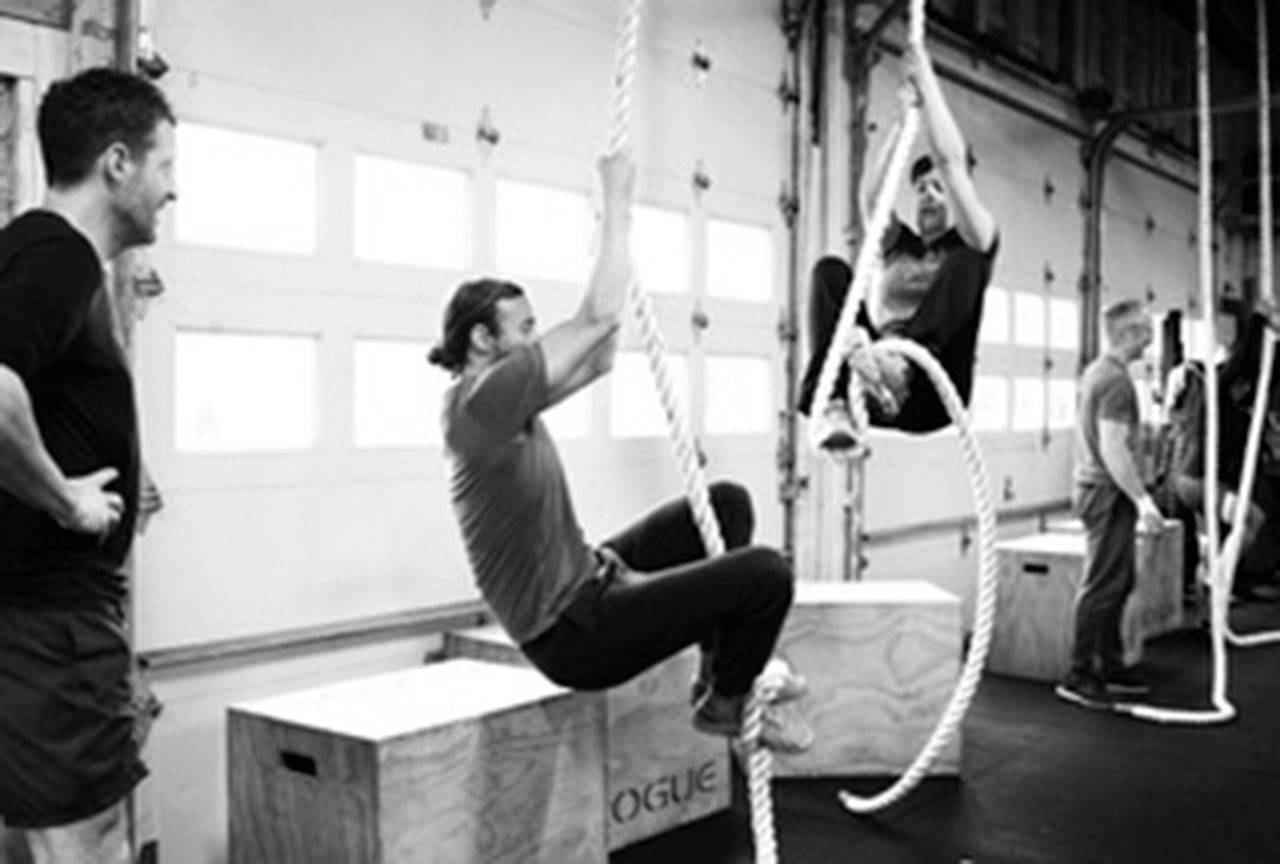 From left: Damon Lanphear, Max Baumann and Laura Cherry learning the ropes at CrossFit Vashon. (Brian Lee Photo)