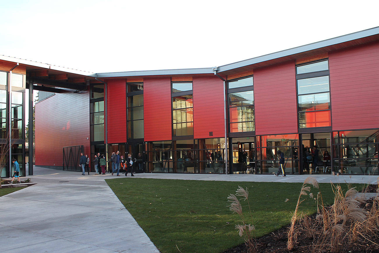 Amid raises and reductions, school district passes budget