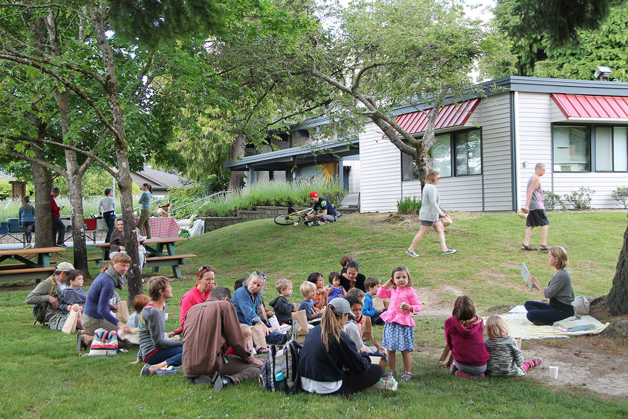 Storytime for children attending the Picnics in the Parks program draws a crowd last year (Paul Rowley/Staff Photo).