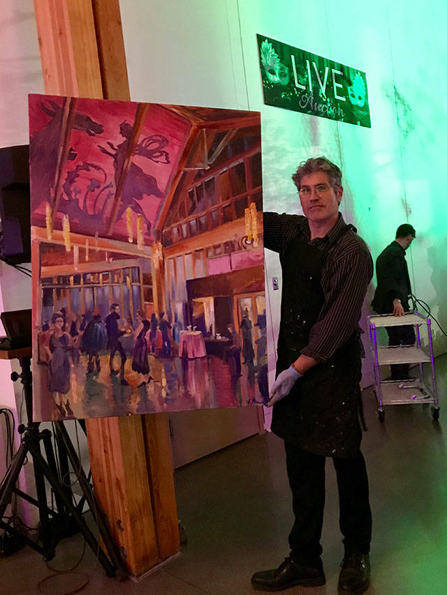 Steffon Moody poses with his top-selling painting, created on the spot during Vashon Center for the Arts’ annual art auction (Courtesy Photo).