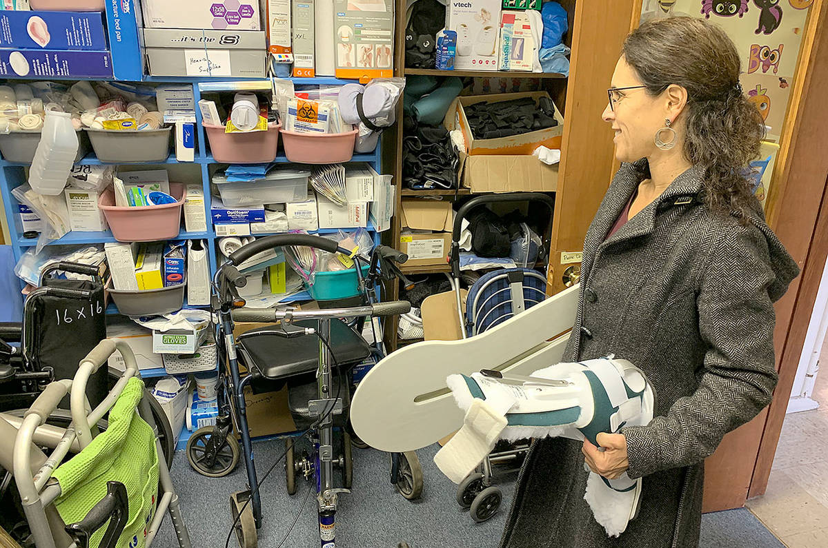Kim Eckhardt, a physical therapist, picks up equipment for patients from the “care closet” at Vashon’s Lutheran church on Monday, Oct. 21 (Kevin Opsahl/Staff Photo).