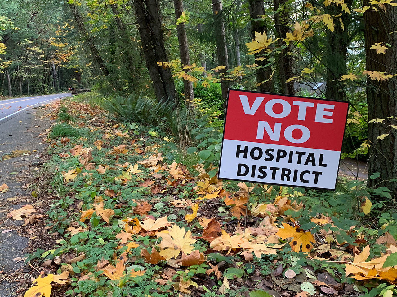 A sign urging islanders to vote against the proposed public hospital district is seen along Vashon Highway on Friday, Oct. 25 (Kevin Opsahl/Staff Photo).