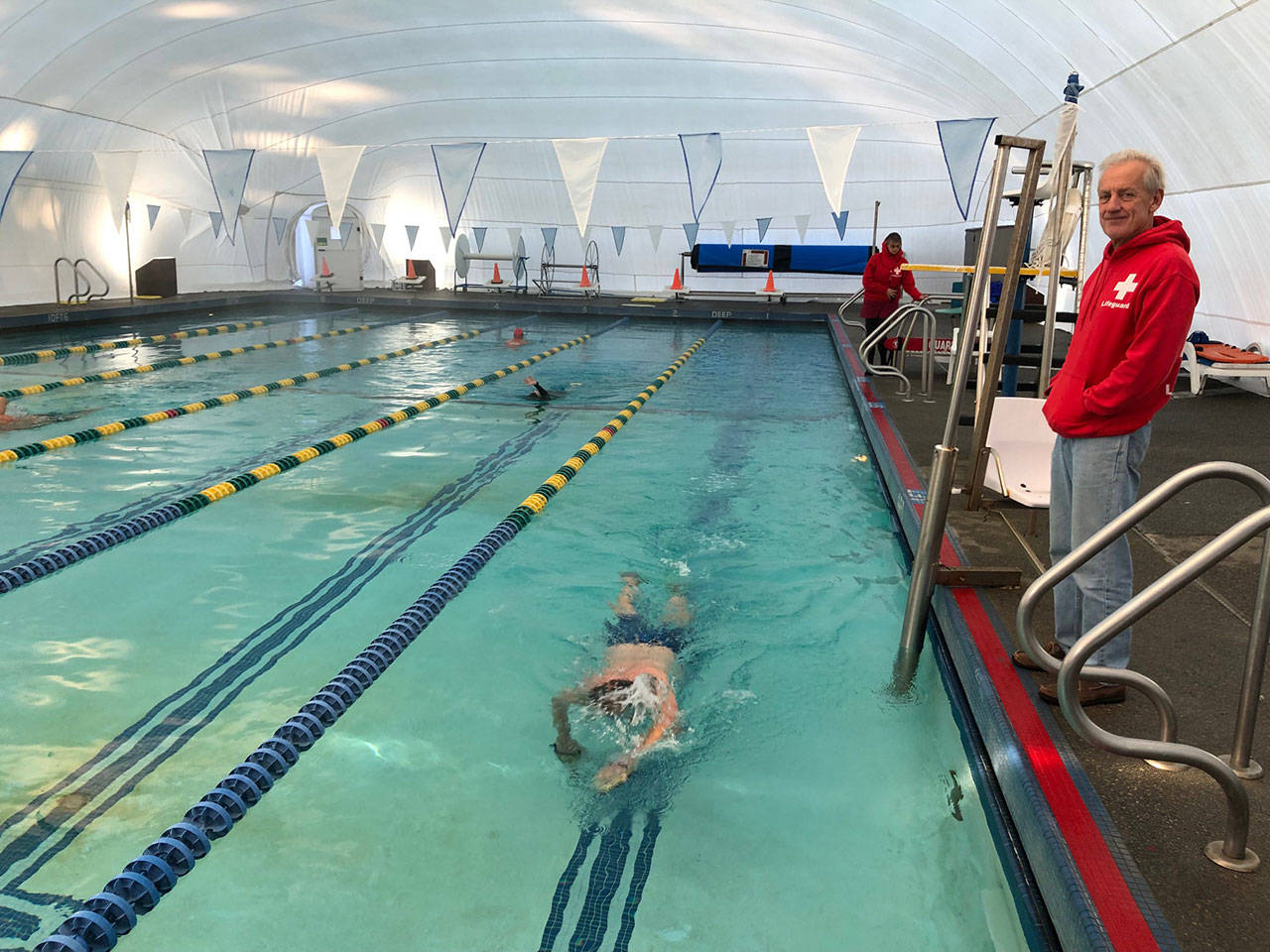 Rob Luke and Eric Hefflefinger, in the pool, are just two of the adult lifeguards at the Vashon Pool (Kate Dowling/Staff Photo).