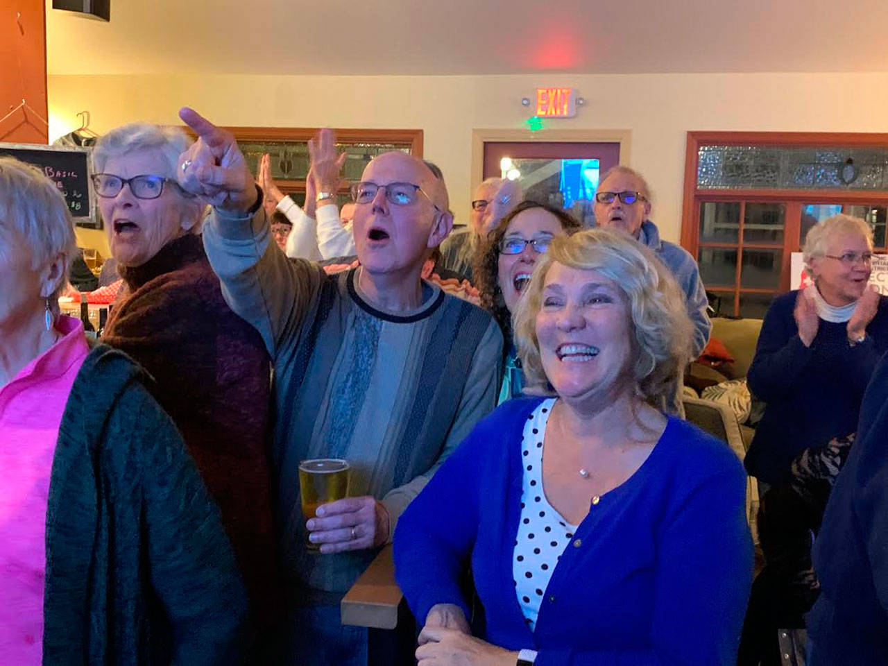 Eric Pryne, left, reacts to election results with LeeAnn Brown, right, at the Vashon Brewing Community Pub on Tuesday, Nov. 5 (Kevin Opsahl/Staff Photo).