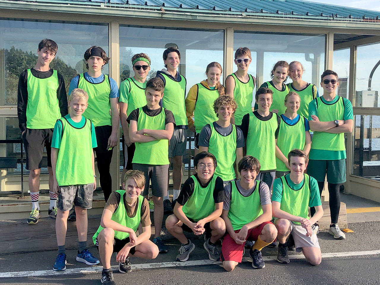 The Vashon Island High School cross country team stands at the entrance of the Tahlequah ferry terminal on Thursday, Nov. 7, for the Dock2Dock competition (Courtesy Photo)