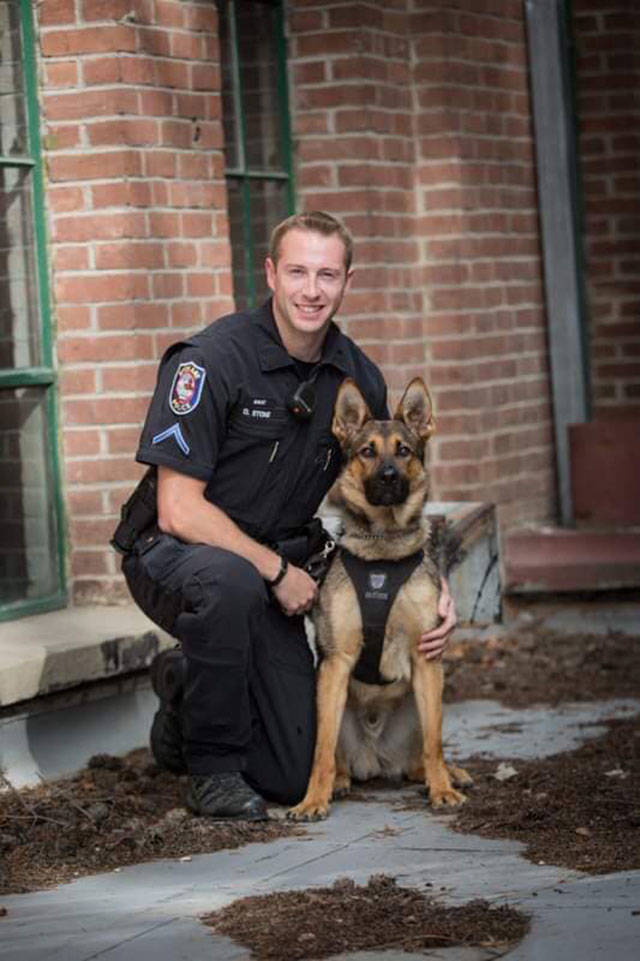 Officer David Stone of the Spokane Police Department K-9 unit poses with 19-month-old German Shepherd, Haywire (Spokane Police Department Photo).