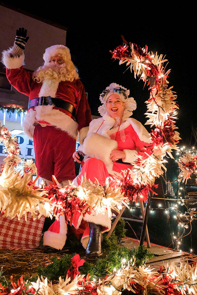 Santa and Mrs. Claus greet onlookers during the 2019 Winterfest event, sponsored by the Vashon-Maury Island Chamber of Commerce. The Christmas couple participated in a parade before lighting the holiday tree at Vashon Village (Kent Phelan/vashonpics.com Photo).
