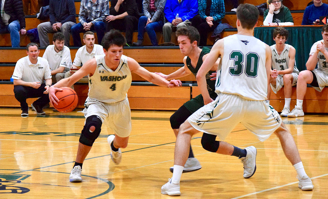 Jeremiah “JJ” Bogaard, senior guard, dribbling the basketball, as his teammate, senior forward Isaac Patchen (jersey No. 30) looks on (Pam Stenerson Photo).