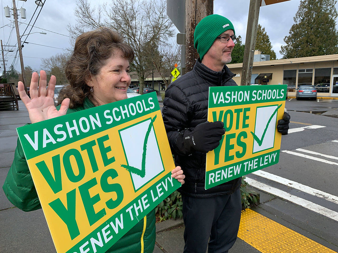 Kevin Opsahl/Staff Photo                                Rheagan Sparks, chairwoman of the Vashon Island School District board of directors, and district superintendent Slade McSheehy told signs supporting the Cap/Tech levy on Saturday, Feb. 8, just days before the special election on Tuesday.