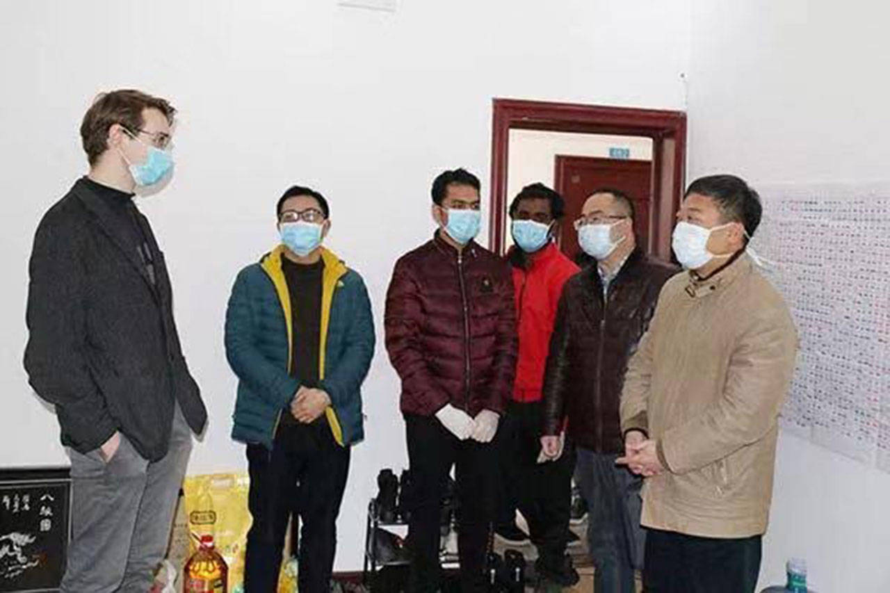 Alex Witherspoon, an alumnus of Vashon Island High School, speaks with Chinese officials at Hubei Minzu University, the school where he is studying and has not left since January due to the COVID-19 outbreak. (Courtesy Photo)