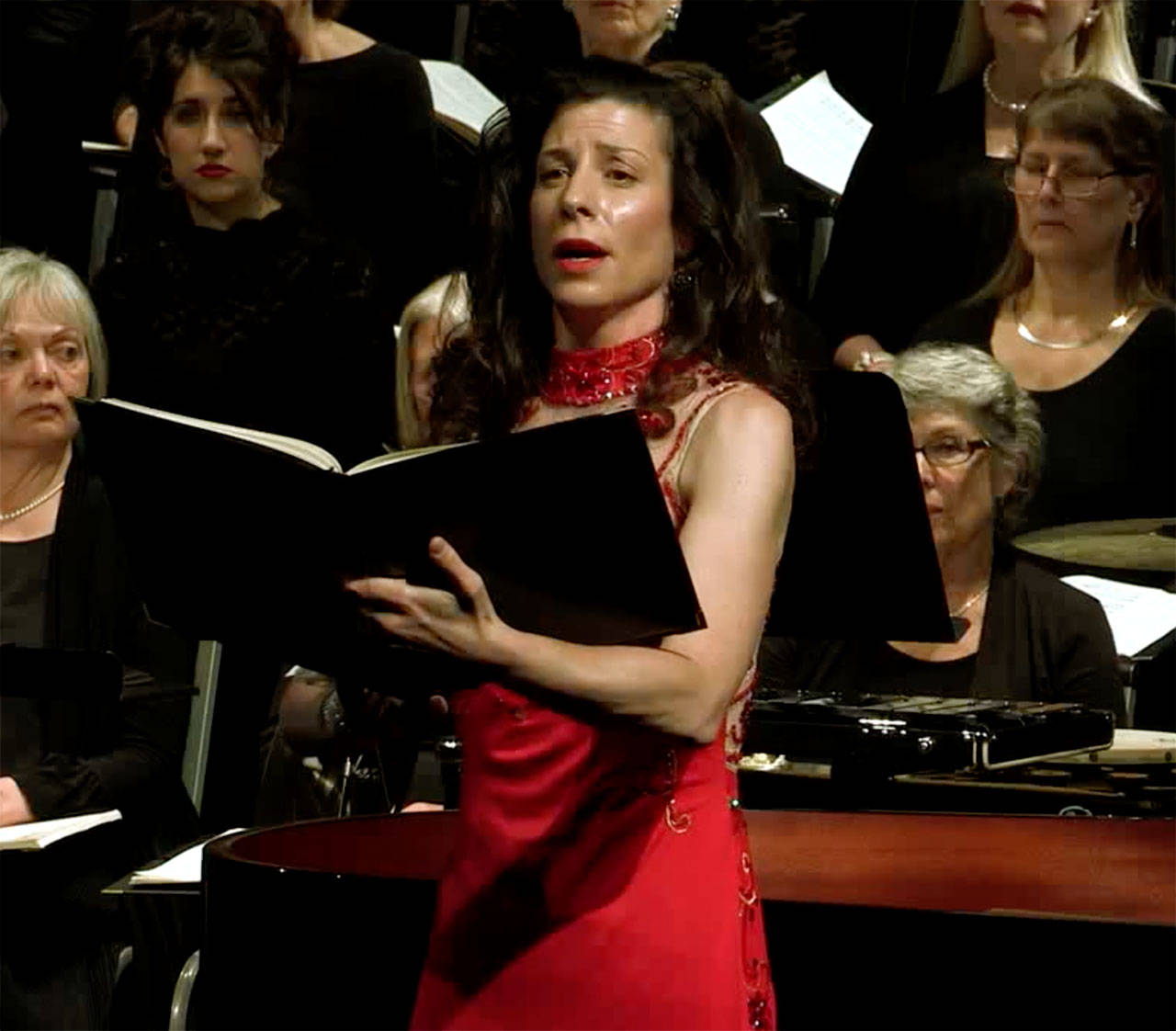 Vashon Opera co-founder Jennifer Krikawa sings with the Vashon Island Chorale in the debut performance at the Katherine L White Hall, in 2016. The performance is now available for free on Vashon Center for the Arts T.V., at vashoncenterforthearts.org (Photo from video by Peter Ray and Michael Monteleone for Voice of Vashon).