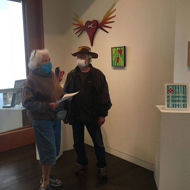 Longtime VCA members Patty and Bob Custer were among the first visitors to VCA’s reopened gallery, where a show called “Hearts of Resilience” hangs. VCA is taking 20 percent of the sales in the show, reserving the other 80 percent to go to local nonprofits and the artists (Elizabeth Shepherd Photo).