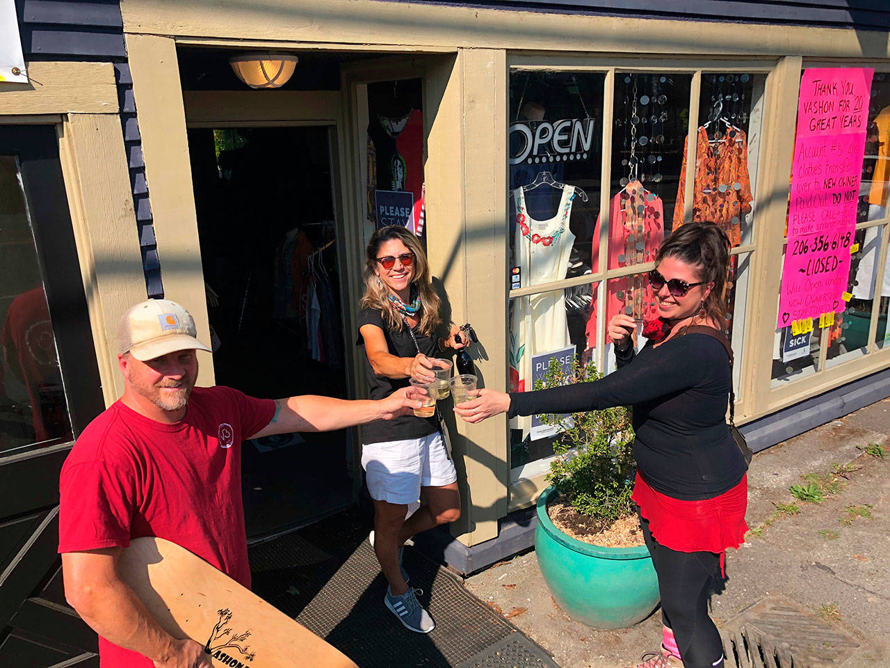 (From left to right) Dustin Landry, Diana Anderson and Tesse Crocker toast the future of Vashon Boards and Luna Bella’s Women’s Consignment Boutique (Courtesy Photo).