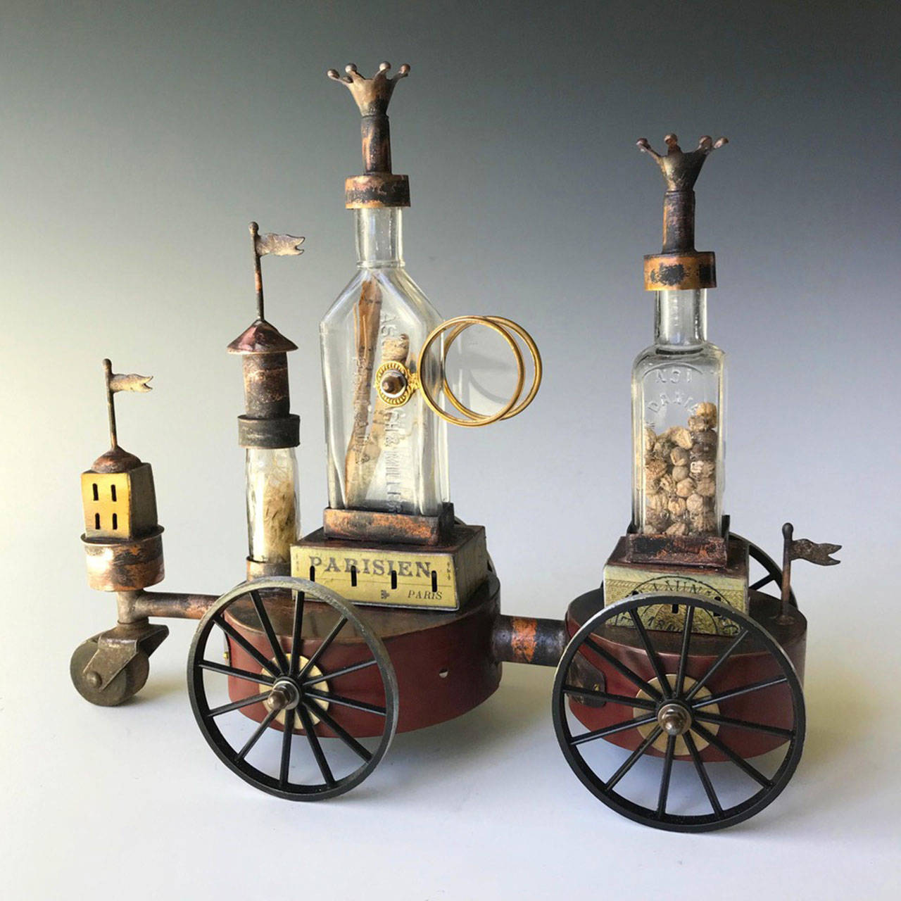 “Possibilities,” by Morgan Brig, is wheeled copper artwork made with three vintage glass bottles from the collection of VIPP founder Barbara Drinkwater (Courtesy Photo).
