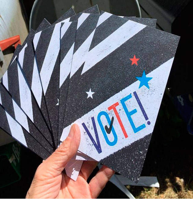It’s all in a day’s work for Vashon volunteers to send hundreds of postcards a day to voters nationwide (Photo courtesy Vashon Indivisible).