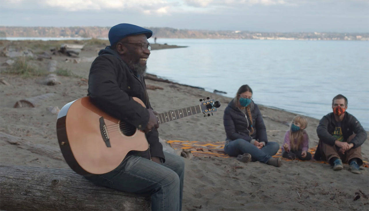 Clinton Fearon sings on KVI Beach in the video for his new single, “Fix It” (Courtesy Photo).