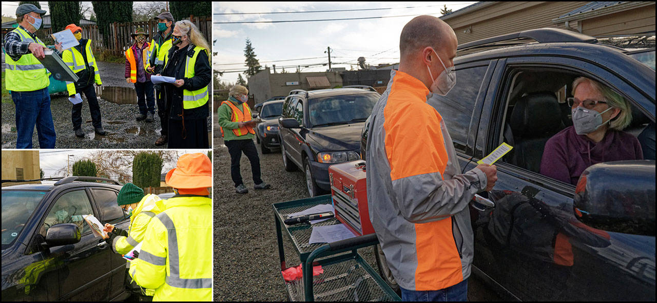 A group ran a test last week at Vashon Pharmacy. Members of Vashon’s Community Emergency Response Team (CERT) gathered for their briefing on the patient arrival process (top left). The CERTs also practiced the check-in system because appointments will be mandatory at the site (bottom left). Pharmacy owner Tyler Young was at the parking lot where mock patients were lined up so the procedure could be tested for vaccinating patients while seated in their vehicles (right). Volunteers from the Medical Reserve Corps (MRC) have been heavily involved in planning and will work at the site to provide the required post-vaccination observation period (Rick Wallace Photos).