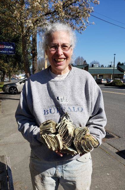 Hilary Emmer received the first large donation to Vashon’s Virus Rent Fund — a bag filled with $1 dollar bills — on March 18, 2020 (Courtesy Photo).