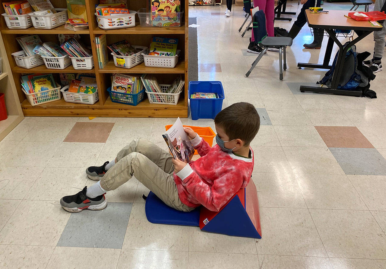 A student stays comfy and distanced in new floor seating purchased with a grant from Partners in Education (Courtesy Photo).