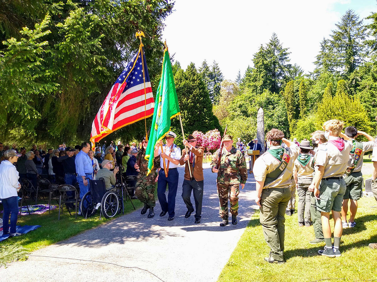 The Color Guard, led by Commander John Burke, retires the colors after the Memorial Day ceremony at Vashon Cemetery on Monday (Paul Rowley Photo).