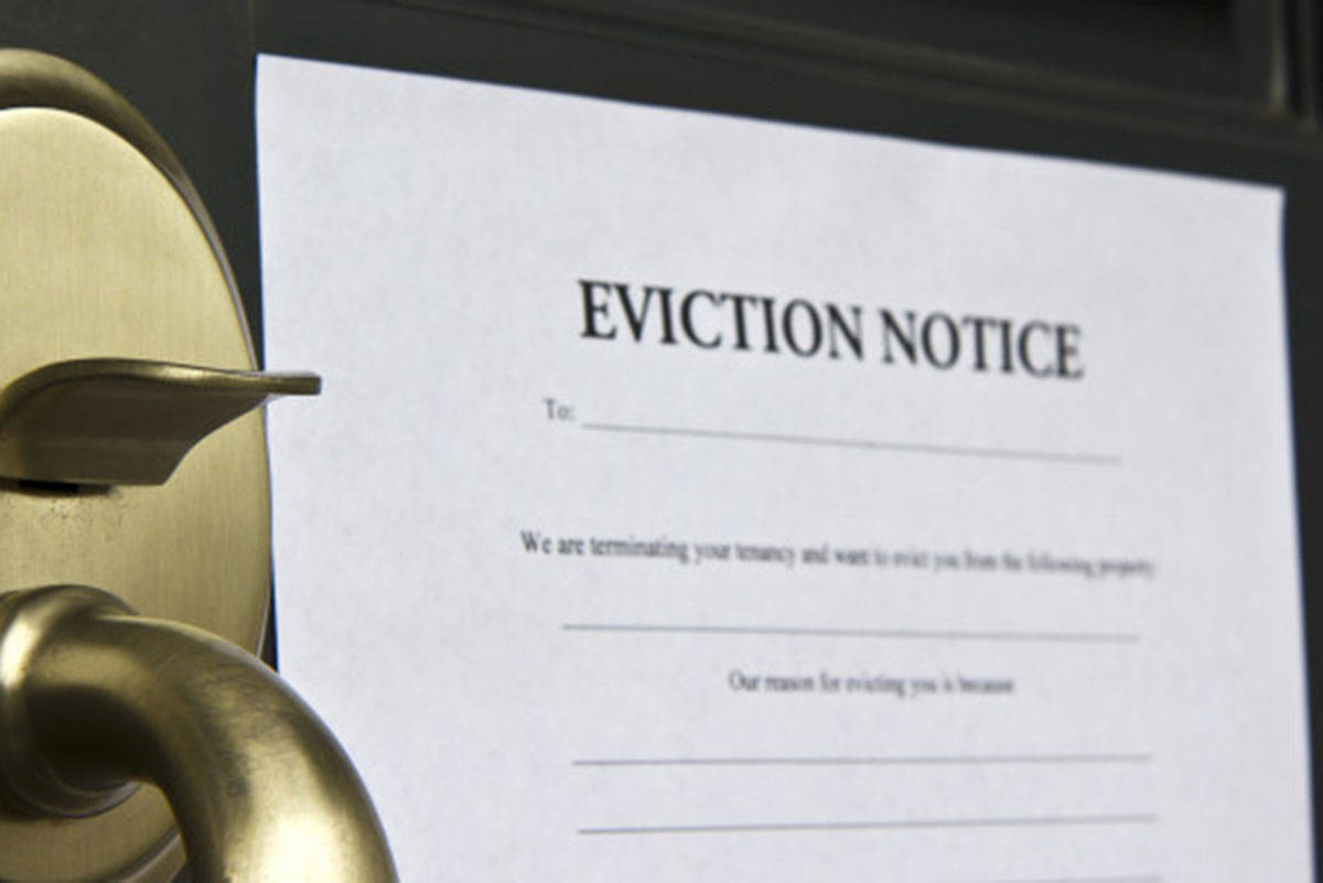 Eviction notice letter pasted on front door of house. File photo