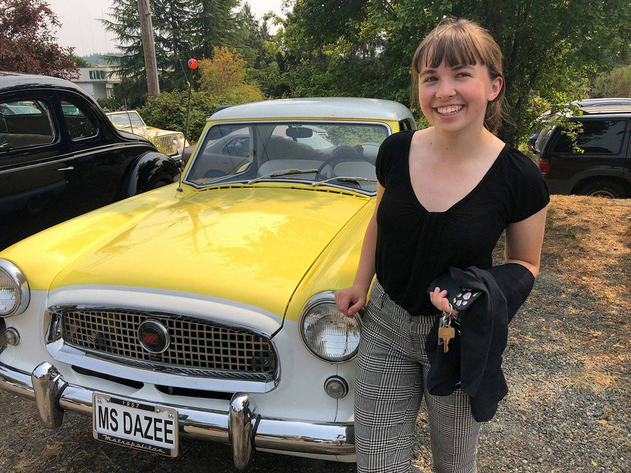 Islander Ellie Hughes posed beside her favorite “dream-mobile” at the 2018 car show at Engels Repair and Towing (Tom Hughes Photo).