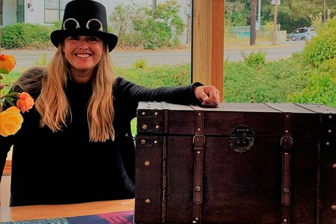 (Courtesy Photo)
Jordan Balcom, a board member of Vashon Center for the Arts, shows off a steamer trunk filled with more than $2,500 worth of high-end items and experiences. The trunk is being raffled off as part of VCA’s annual art auction.