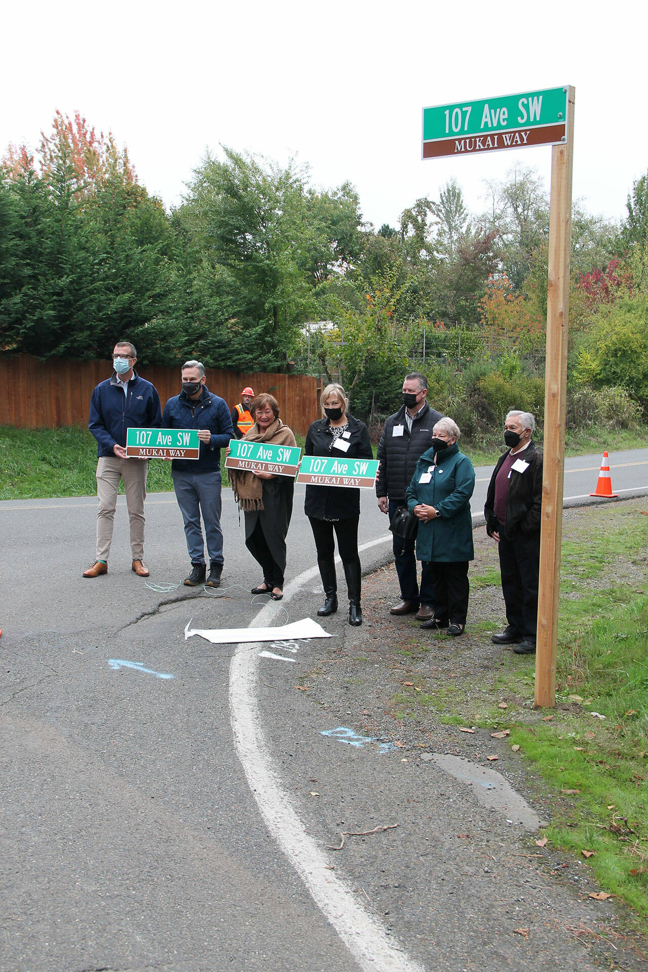 (Jenna Dennison Photo)
King County Councilmember Joe McDermott, King County Executive Dow Constantine, Friends of Mukai President Rita Brogan, and descendants of the Mukai family stand with the unveiled sign for “Mukai Way.”
