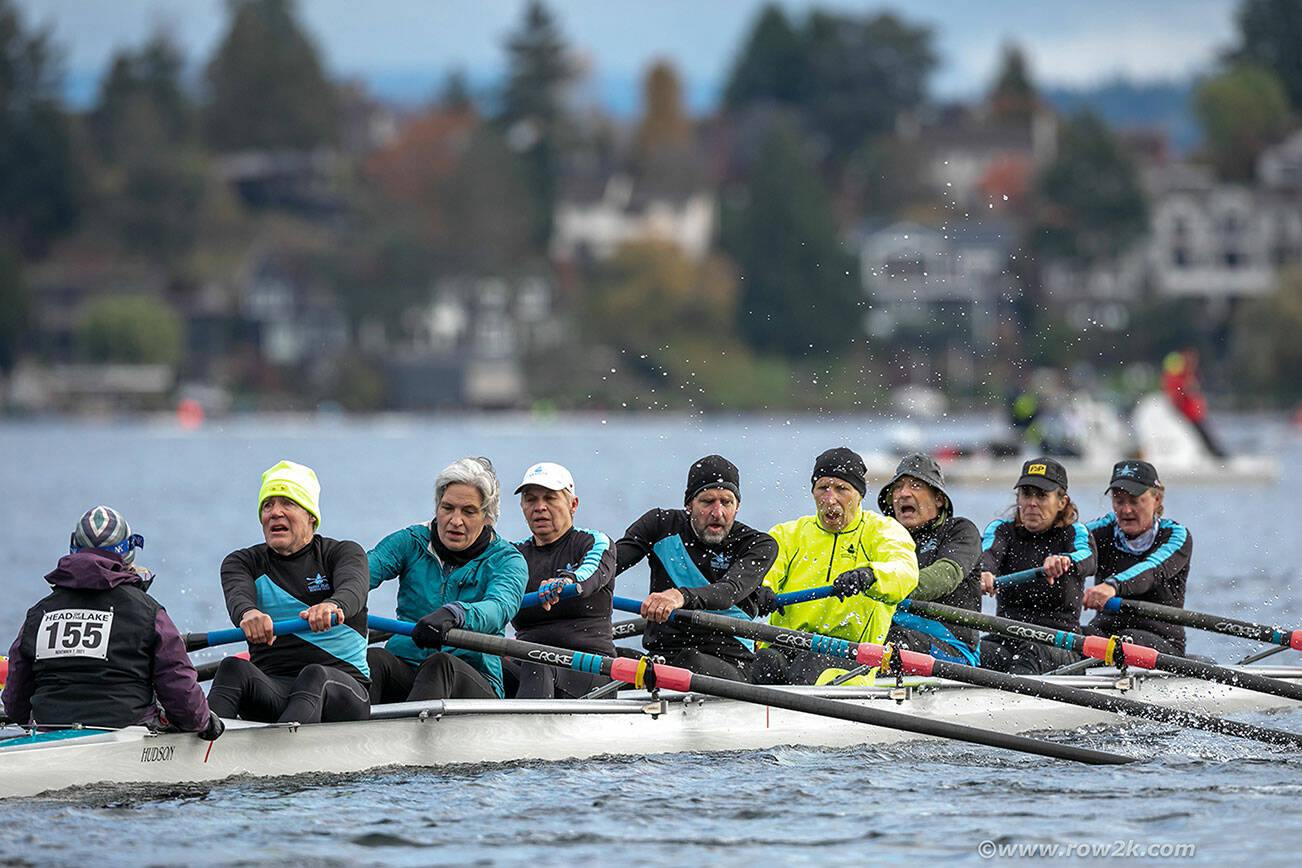 (Erik Dresser, row2k.com Photo) Vashon Island Rowing Club’s Mixed 8, having way more fun than it looks, rowed through rain and wind to capture gold for the fourth consecutive year at Seattle’s Head of the Lake Regatta through the Montlake Cut, on Nov. 7. From left to right: Coxswain Lisa Huggenvik, Bruce Morser, Kit Gruver, Kim Goforth, Bob Horsley, John Jannetty, Mark Burns, Zabette Macomber and Lea Heffernan. The average age in the boat? 62.6 years. For Jeff Hoyt’s full account of the regatta, see page 10.