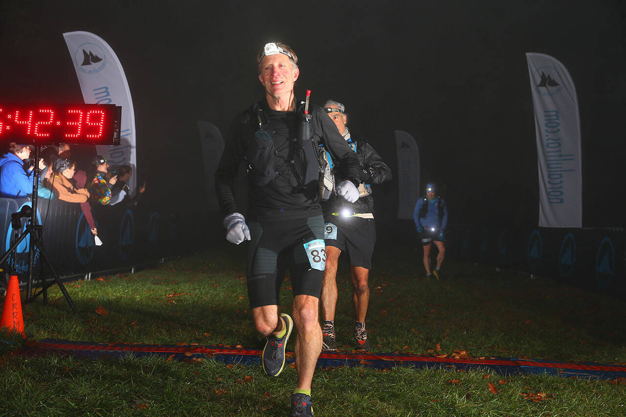 (Photo Courtesy Facchino Photography) Bruce Cyra crosses the finish line of the Rio del Lago 100-mile race.