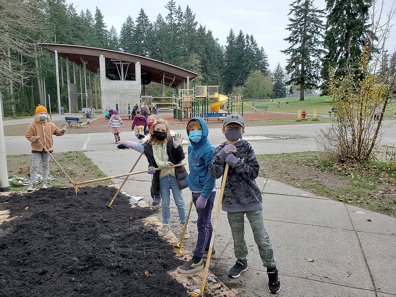 (Courtesy Photo)	Second-graders at Chautauqua Elementary School take a break from their work in building a native pollinator garden outside their classroom window.