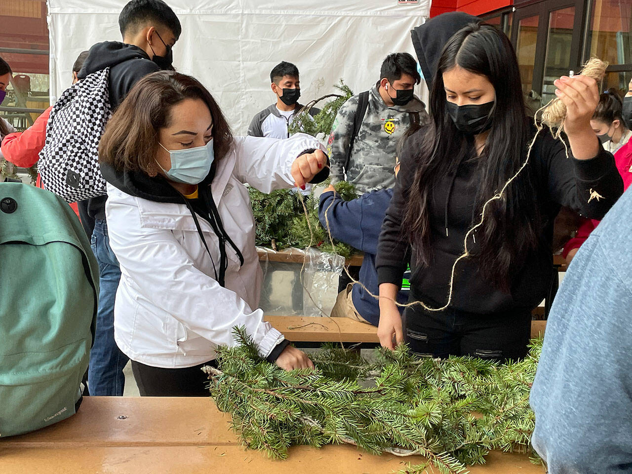 (Courtesy Photo) Nidia Sahagun, Vashon Island School District’s family engagement coordinator, works with students in VHS’s LatinX student club to construct wreaths. The project was undertaken with Valeria Martinez Espinoza, from Vashon Nature Center.