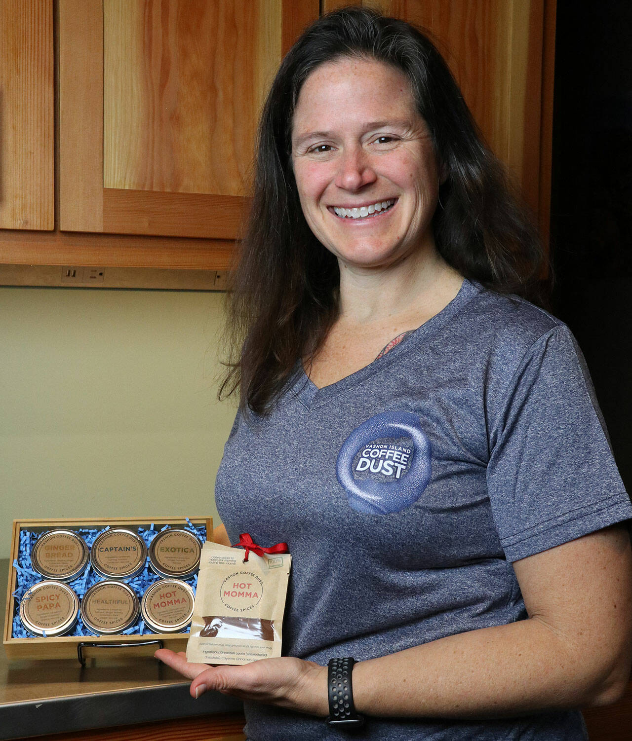 (Photo Courtesy Christy Clement) Christy Clement, owner of Vashon Island Coffee Dust, with the current spice blends made by her company.