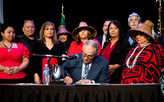 Tulalip council members and tribal members watch as Governor Jay Inslee signs bill HB 1571 into law at the Tulalip Resort on Thursday, March 31, 2022 in Tulalip, Washington. (Olivia Vanni / The Herald)