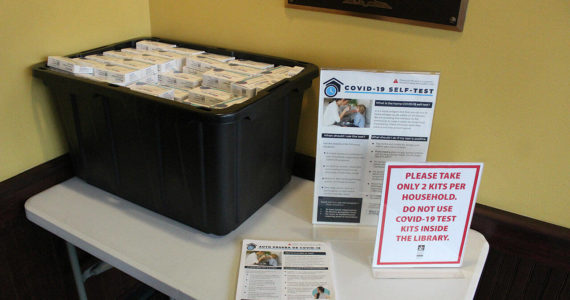 The Enumclaw library passes out free at-home rapid COVID tests last January. Sound Publishing file photo