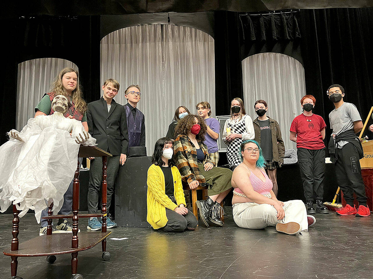(Andy James Photo) The cast of “A Spirited Manor,” posing with the show’s spooky mascot, Yulia (in lace dress) includes (back row, left to right) Japhy Tsaitsenhoven, Bishop Townsend, Nathan Campbell, Isaac Huff, Chloe Bay, Harper Hobson, El Otto, Chris Wechkin, Richard Barrett-Wood, and (front row, left to right) Phoebe Ray, Raena Joyce, Ari Officer. Not pictured: Ian Ingalls.