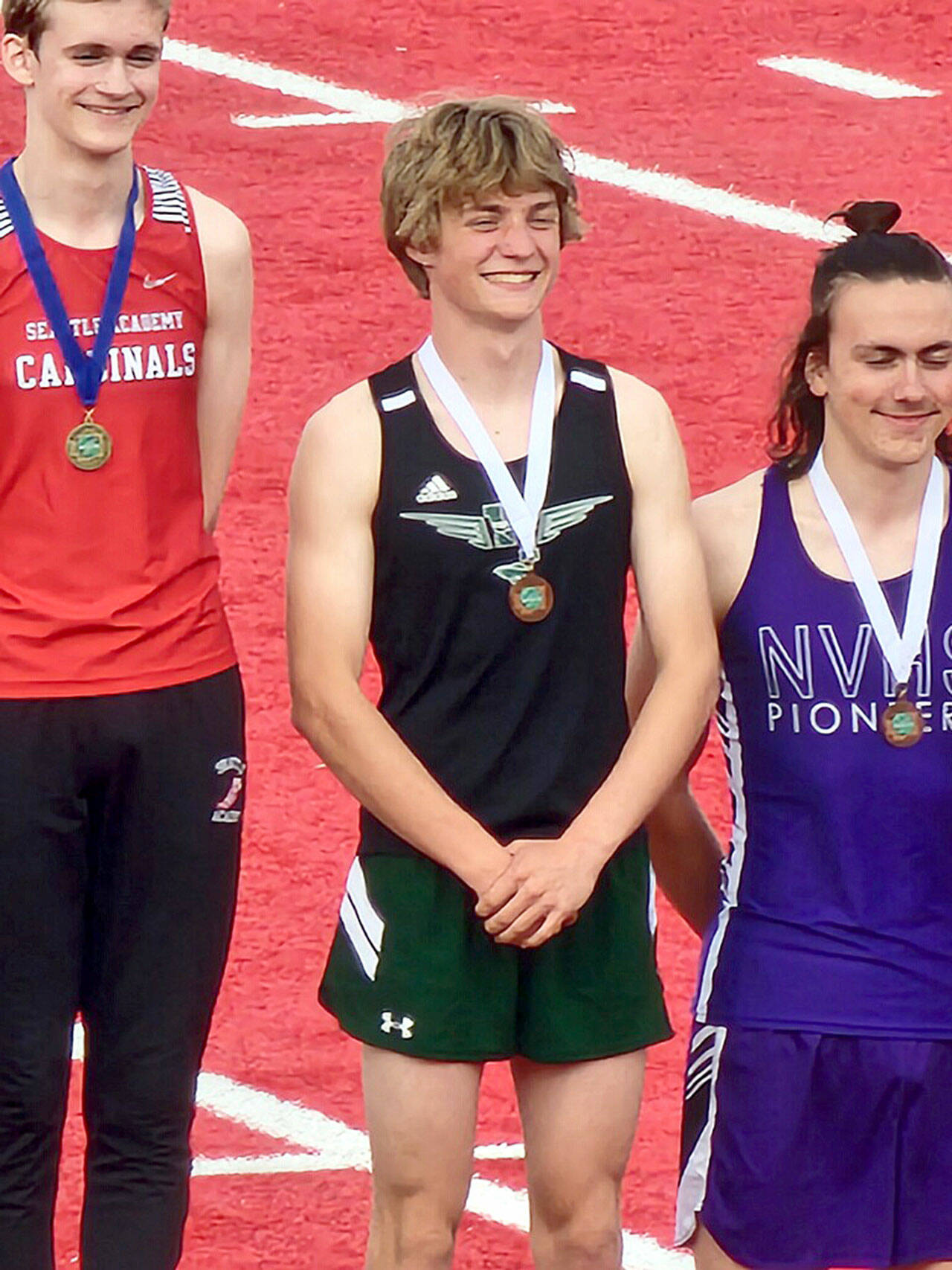 (Blake Gibbons Photo) Senior track athlete George Murphy stands on the awards podium with the third place medal that he received in the boys’ pole vault.