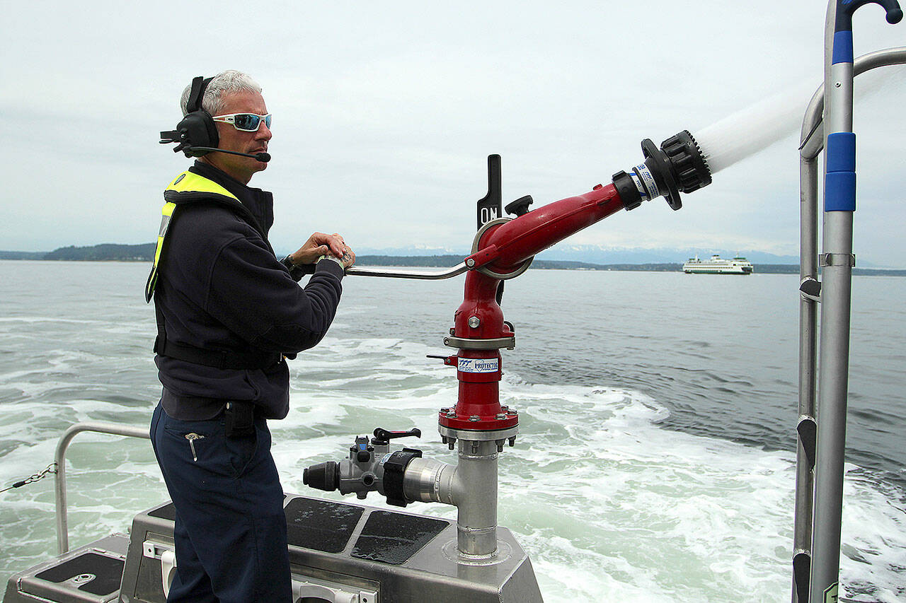 (Olivia Sullivan/The Mirror Photo) South King Fire’s Merrick McGinnis demonstrates the water canon on fire boat “Zenith” on May 26.