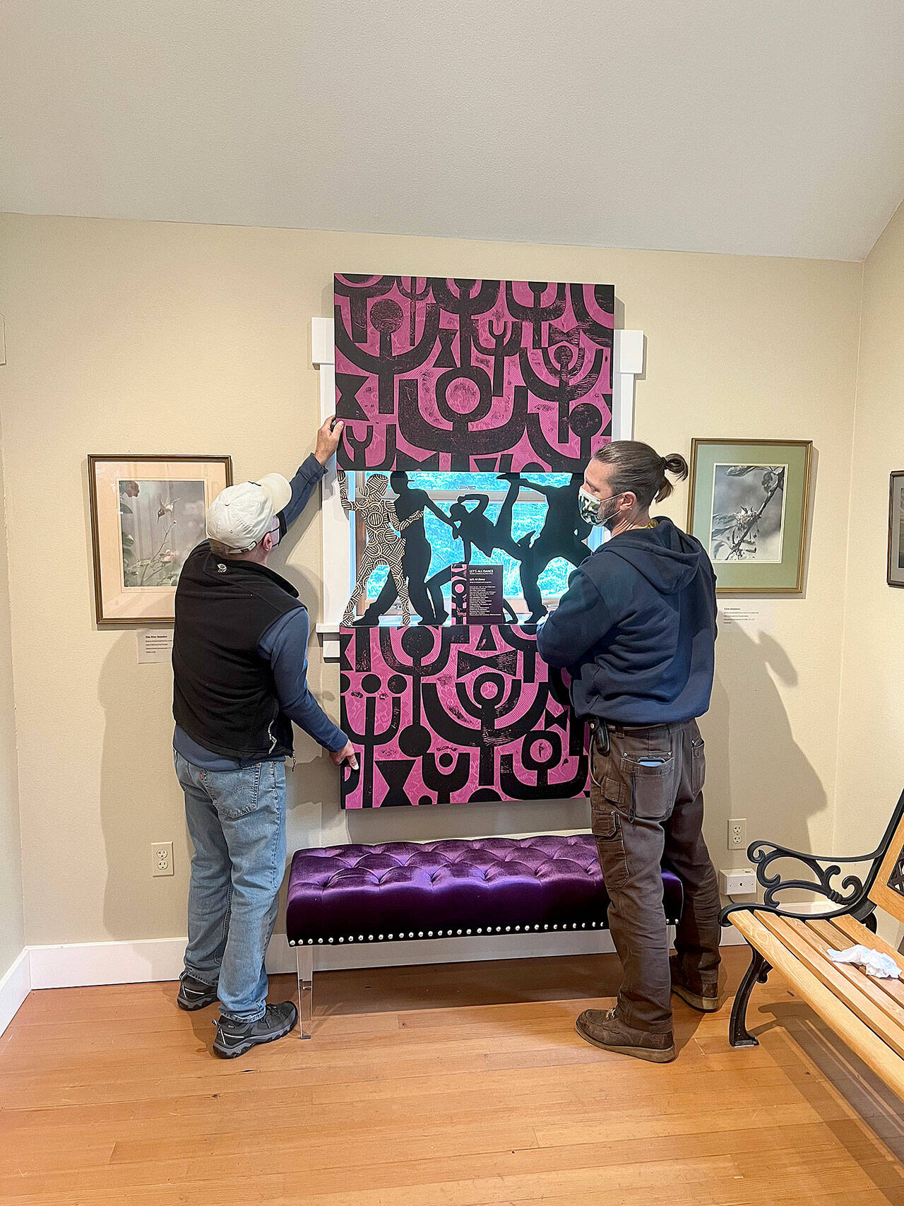 (Courtesy Photo) Bob Katica and Walker Dodson install “Let’s Dance,” a wood carving by Brian Fisher that was included in Vashon Heritage Museum’s award-winning exhibition, “In and Out: Being LGBTQ on Vashon.” The artwork is included in the museum’s online auction, running June 11 to 25.