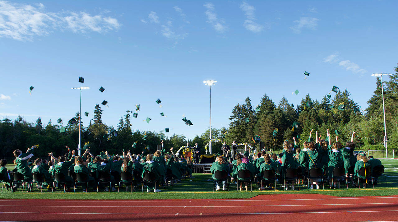 (Jenna Dennison Photo) The Vashon Island High School Class of 2022 tosses their caps into the air following the conclusion of Saturday’s Commencement.
