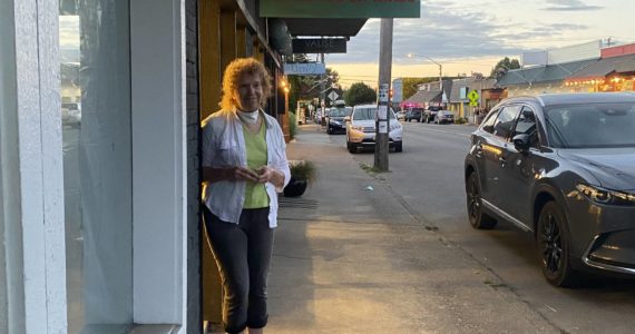 Alice Larson stands outside of Island Paper Chase, which closes its doors at the end of the month. (Tom Hughes Photo)
