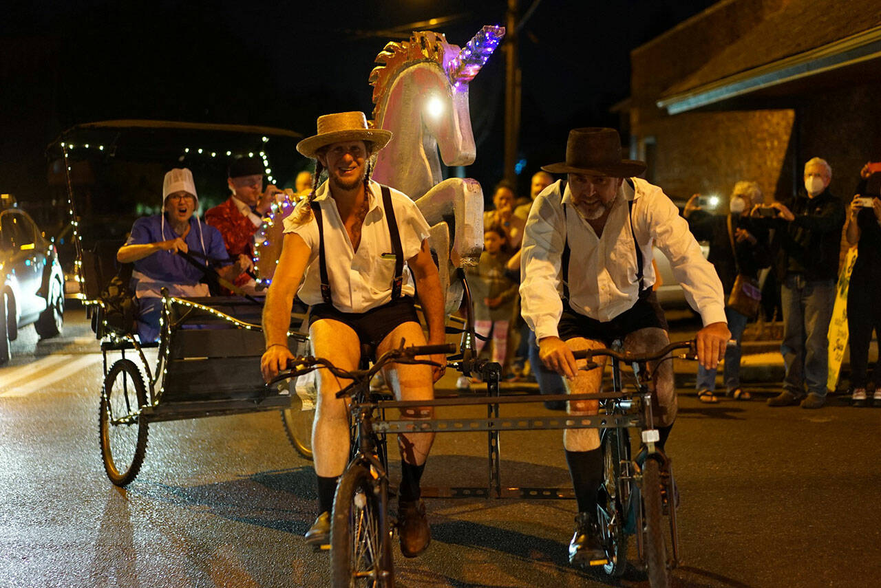 Jason Culp (in hotpants, left) and crew added a sparkling unicorn to their Amish buggy bike. (Pete Welch Photo)
