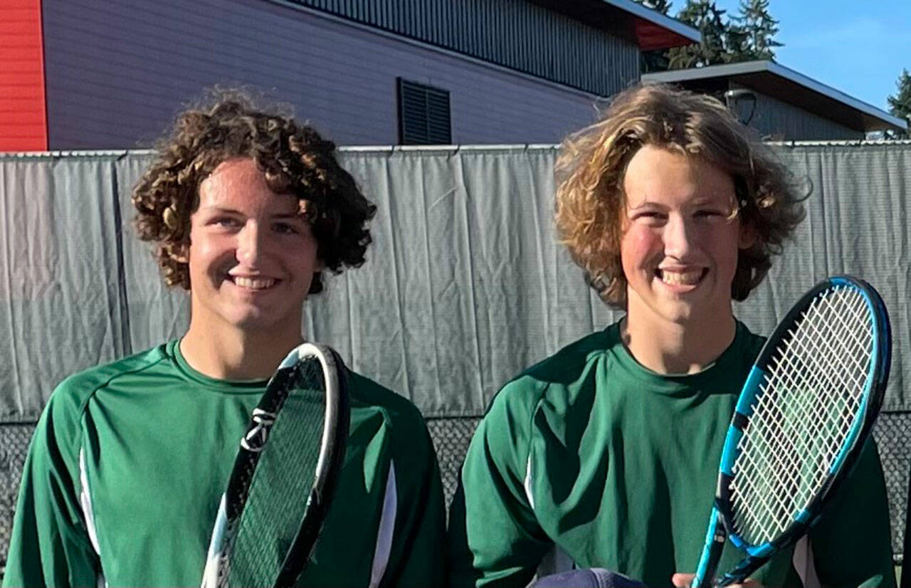 Singles players Nick Zuckerman (left) and Moses Trundle-Strachan had plenty to smile about after three wins for boys’ tennis on Vashon. (Rick Doussett Photo)