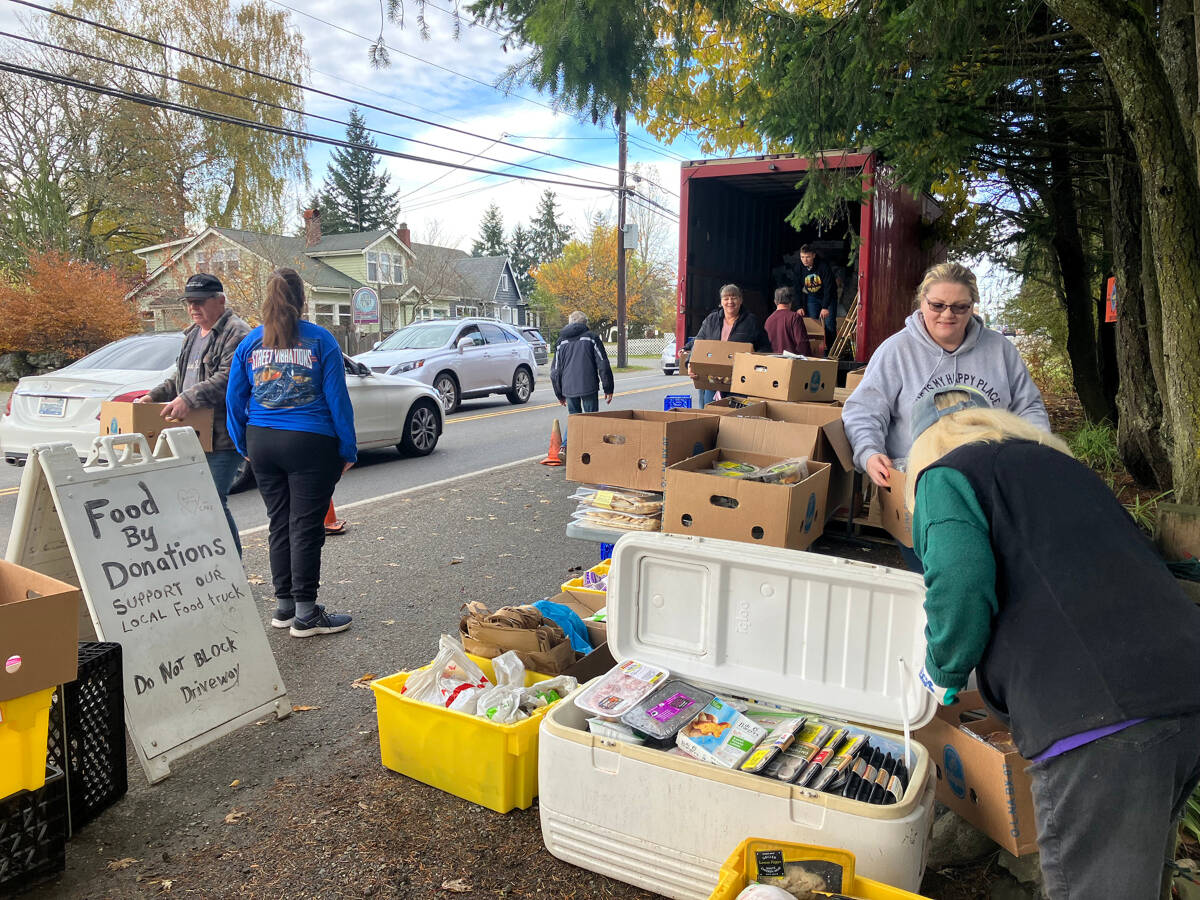 The day before Thanksgiving, a group of volunteers helped stack food high on food tables stocked by a Vashon nonprofit, One in the Spirit Ministries (Elizabeth Shepherd Photo).