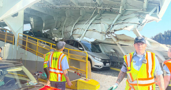 In the immediate aftermath of the crash of the Cathlamet in July 2022, ferry workers and passengers surveyed the serious damage to the boat, which pinned one car in folded steel. (Photo courtesy of Pam Kirkpatrick)