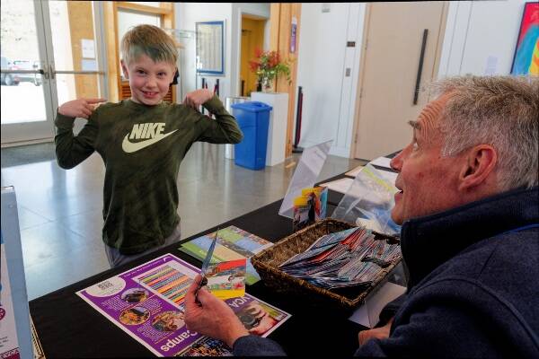 Local artist Bruce Morser greets Declan Baer at a recent Vashon Center for the Arts event for families (Rick Wallace Photo).