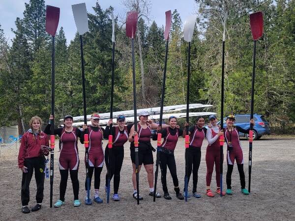 (Left to right) Caroline Barnes, Taylor Huffman, Ella Jones, Paige Gibbons, Haley Hopper, Sacia Thompson, Brisa Ordonez, Keziah Rutschow, and Ella Odegard pose for a picture after their successful row in an 8. They didn’t realize it at the time, but the club’s new 8 is behind them in the picture, generously donated by the University of Oregon (Eric Odegard Photo).